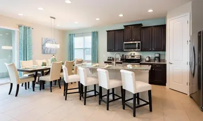 a kitchen and dining room with a table and chairs at 7412 MA - Stylish Home Near Parks in Orlando