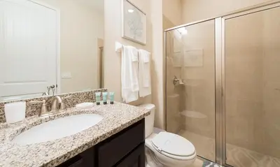a bathroom with a toilet and a sink and a shower at 7412 MA - Stylish Home Near Parks in Orlando
