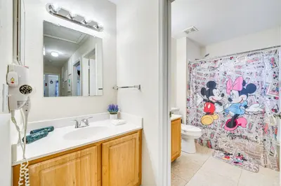 a bathroom with a sink and a toilet and a shower at 14 Mi to Disney World Kissimmee Condo with Perks! in Kissimmee