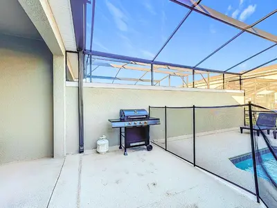 a grill sitting on the side of a patio at Incredible Family Retreat with PS5 Private Pool and access to 2 Clubhouses in Kissimmee