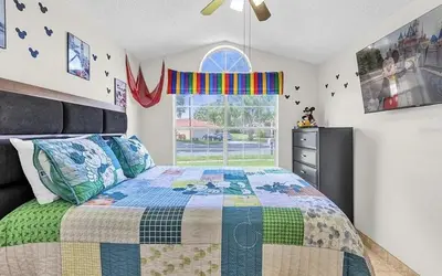 a bedroom with a bed and a window at Cozy Home Near Disney With Private Pool in Kissimmee