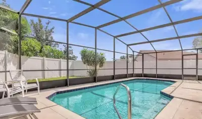 an indoor swimming pool with a pergola next to a swimming poolvisor at Cozy Home Near Disney With Private Pool in Kissimmee