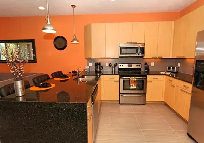 a kitchen with wooden cabinets and a counter top at 17413 Luxury Pool Villa Serenity Haven, 3BR, Balcony in Orlando