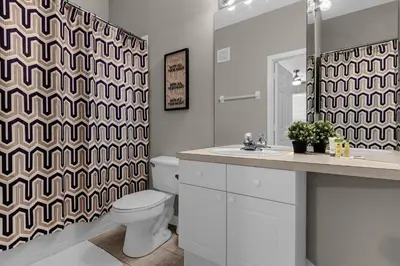 a bathroom with a toilet and a shower curtain at 2306 SP - Disney Paradise 2BR Villa, Near Magic & More in Kissimmee
