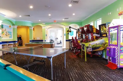 a room with a ping pong table and arcade games at 2306 SP - Disney Paradise 2BR Villa, Near Magic & More in Kissimmee