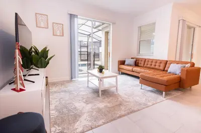 a living room with a couch and a table at 2604 - Luxury 4-BR Villa with Private Pool Retreat in Kissimmee
