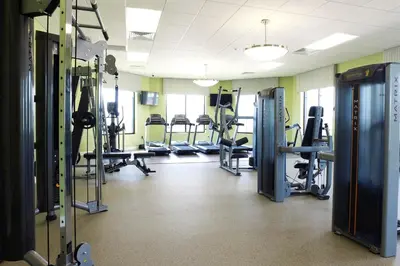 a gym with several treadmills and machines at 2604 - Luxury 4-BR Villa with Private Pool Retreat in Kissimmee