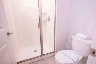 a bathroom with a shower and a toilet at 2901 SS Discover Opulence 4-Bedroom Villa with Pool, and Magical Themed Rooms! in Kissimmee