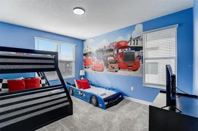 a bedroom with a train mural on the wall at 2940 - Elegant 5BR Villa at Storey Lake Resort Comfort Luxury and Proximity Disney and Universal in Kissimmee