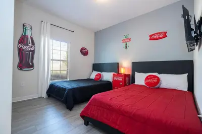 a bedroom with a coca cola sign on the wall at Opulent 5 BR Villa Private Pool - 12 Guests - 3085 TS in Kissimmee