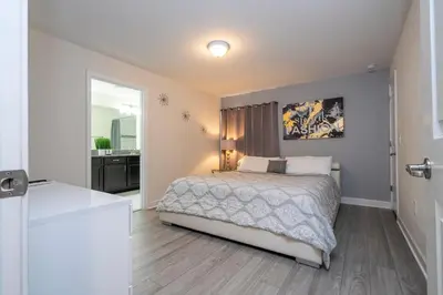 a bedroom with a bed and a bathroom at Opulent 5 BR Villa Private Pool - 12 Guests - 3085 TS in Kissimmee