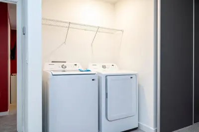 a white washer and dryer in a room at Luxury 3 Bed Home up to 8 guests- The Hub - 3236 TT in Orlando