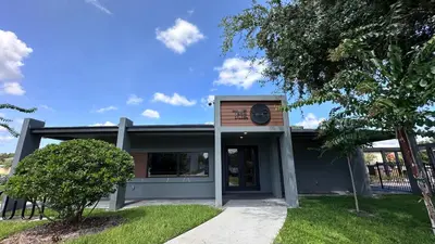 a building with a clock on the front of it at 3258 SW - Luxury Getaway The Hub Relax and Enjoy a Serene Vacation Retreat in Kissimmee