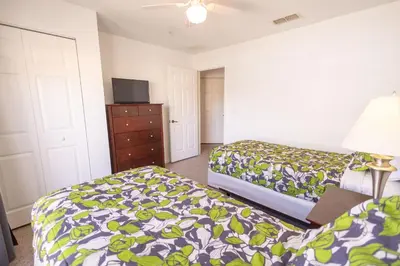 a hotel room with two beds and a dresser at 4562 YR Amazing in Kissimmee