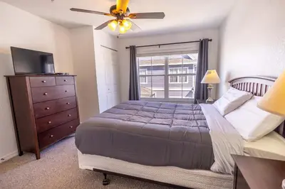 a bedroom with a bed and a dresser and a window at 4562 YR Amazing in Kissimmee
