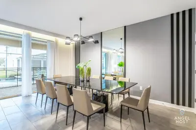 a dining room with a glass table and chairs at In-Home Arcade, Themed Bedrooms, Resort Lazy River in Kissimmee