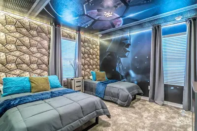 a bedroom with two beds and a stone wall at In-Home Arcade, Themed Bedrooms, Resort Lazy River in Kissimmee
