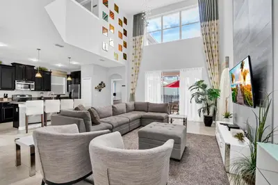 a living room with a couch and a table at 9008 Paradise Palms Blissful Haven 5-Bed Oasis of Luxury and Tranquility in Orlando