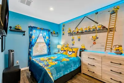 a childs bedroom with blue walls and a bed with yellow accents at Resort Home near Disney Themed Jacuzzi Pool 2609 in Orlando