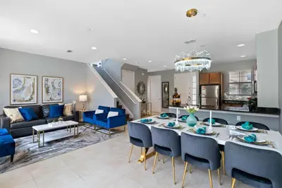 a dining room and living room with a table and chairs at Resort Home by Disney Themed Jacuzzi Pool 2666 in Orlando