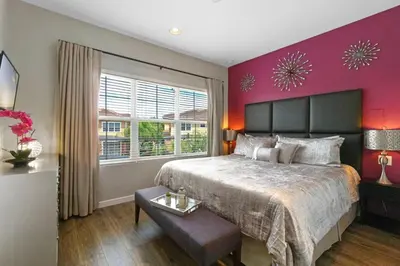 a bedroom with a large bed and a purple wall at Resort Home by Disney Themed Jacuzzi Pool 2666 in Orlando