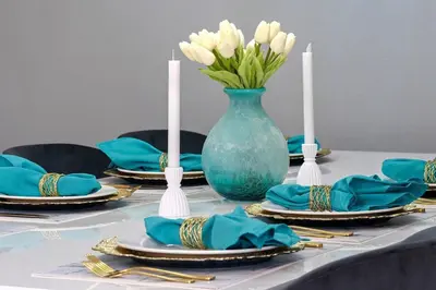a table with blue plates and a vase with white flowers at Resort Home by Disney Themed Jacuzzi Pool 2666 in Orlando