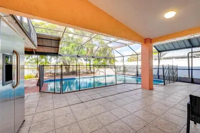 an indoor pool in a building with a glass ceiling at Furnished Lanai and Lake View Quiet Home in Orlando in Kissimmee
