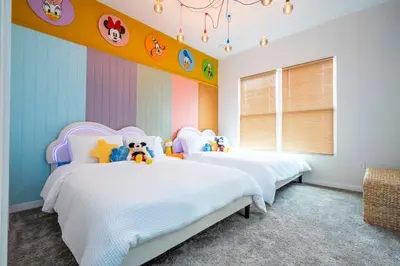 a bedroom with two beds with stuffed animals on them at The Mouse PlayHouse in Orlando