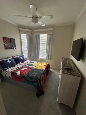 a bedroom with a bed and a ceiling fan at Beautiful Apartment Near Disney in Kissimmee