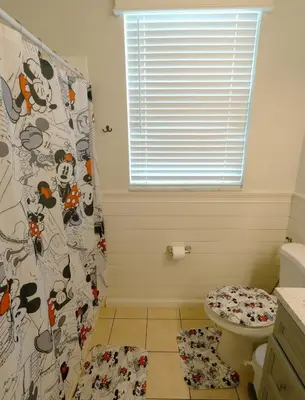 a bathroom with a toilet and a shower curtain at Beautiful Apartment Near Disney in Kissimmee