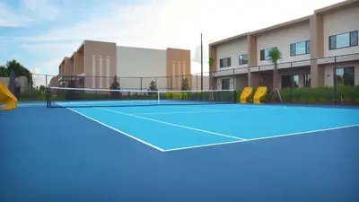 a tennis court in front of a building at Luxury Home 7 Min Disney Universal 3BR4BA - Hot Tub in Orlando