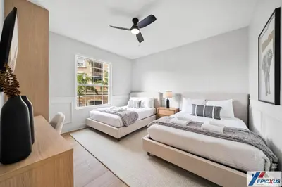 a bedroom with two beds and a ceiling fan at The epic Orlando Vista Cay in Orlando