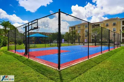 a tennis court with a net in a park at The epic Orlando Vista Cay in Orlando
