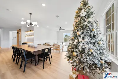 a christmas tree in a dining room with a table and chairs at The epic Orlando Vista Cay in Orlando