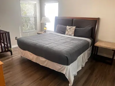 a bedroom with a large bed with a blue comforter at Charming Family Friendly Home in Kissimmee