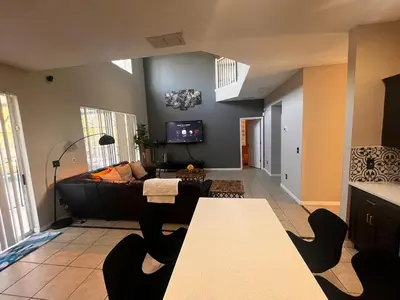 a living room with a couch and a table at Charming Family Friendly Home in Kissimmee