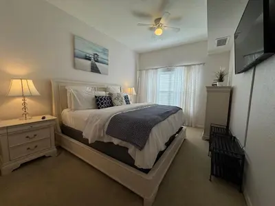 a bedroom with a bed and a television in it at 4 Bedroom 3 Bathroom Villas At SevenDwarfs 31-107 in Kissimmee
