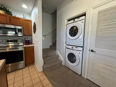 a kitchen with a washer and dryer in a room at 4 Bedroom 3 Bathroom Villas At SevenDwarfs 28-107 in Kissimmee