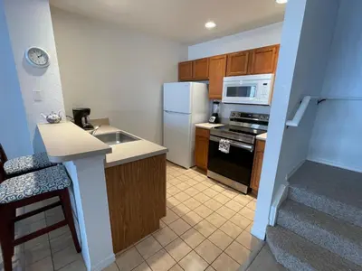 a kitchen with a white refrigerator and a sink at 3 Bedroom 2 Bathroom Villas At SevenDwarfs 19-106 in Kissimmee