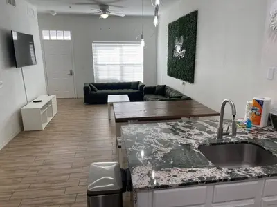 a kitchen and a living room with a counter top at 3 Bedroom 2 Bathroom Villas At SevenDwarfs 15-103 in Kissimmee