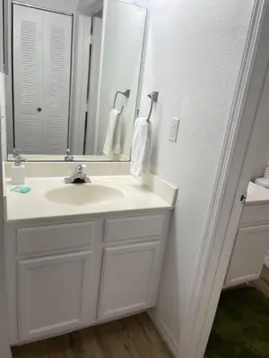 a white bathroom with a sink and a mirror at 3 Bedroom 2 Bathroom Villas At SevenDwarfs 15-103 in Kissimmee