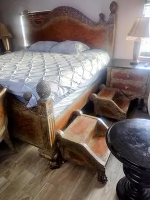 a bed with a wooden frame and a table in a room at A peaceful living vibe in Orlando