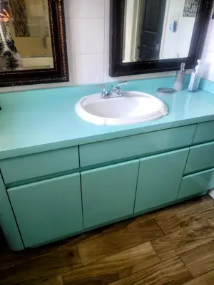 a bathroom with a blue counter with a sink at A peaceful living vibe in Orlando