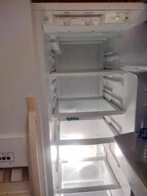 an empty refrigerator with its door open in a kitchen at A peaceful living vibe in Orlando