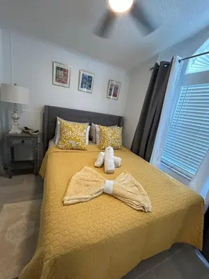 a bedroom with a bed with two towels on it at Your home away from home! Entire cottage- Disney in Kissimmee