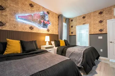 a bedroom with two beds and a painting on the wall at Luxury Lakeview Home Private Pool 2687 in Kissimmee