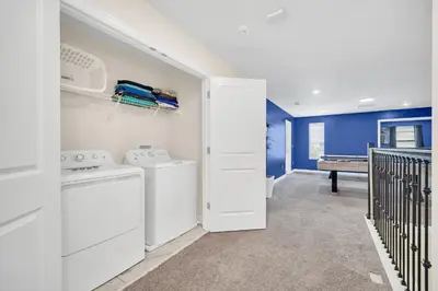 a laundry room with a washer and dryer at Lakefront Luxury Retreat Private Pool & Movie Theater 367 in Kissimmee