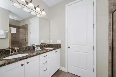 a bathroom with two sinks and a large mirror at Spacious Home With Private Pool, Themed And Game Room Near Disney With Waterpark & Resort Access - 341Pn in Kissimmee