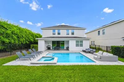 a backyard with a swimming pool and a house at Marvelous Home With Private Pool And Waterpark & Resort Access Near Disney At Encore Resorts Reunion - 7464Mr in Kissimmee