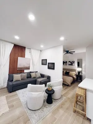 a living room with a couch and two chairs at Modern Guesthouse near MCO in Kissimmee
